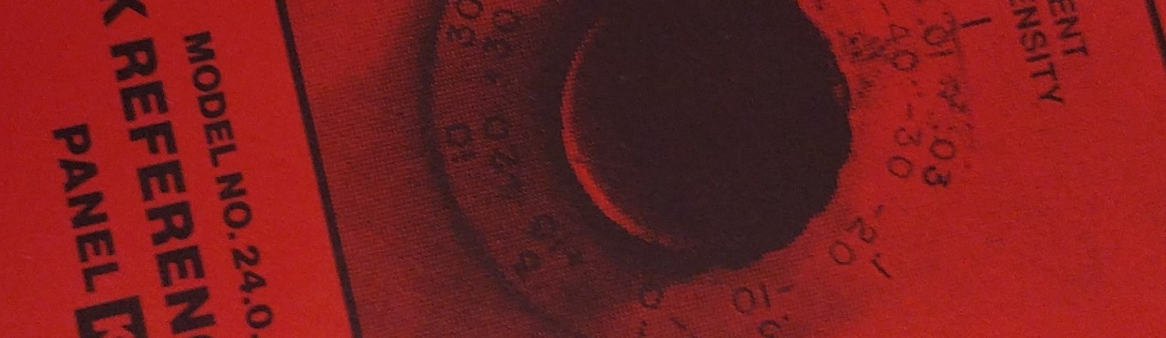 site banner, an image of text and a dial on red paper